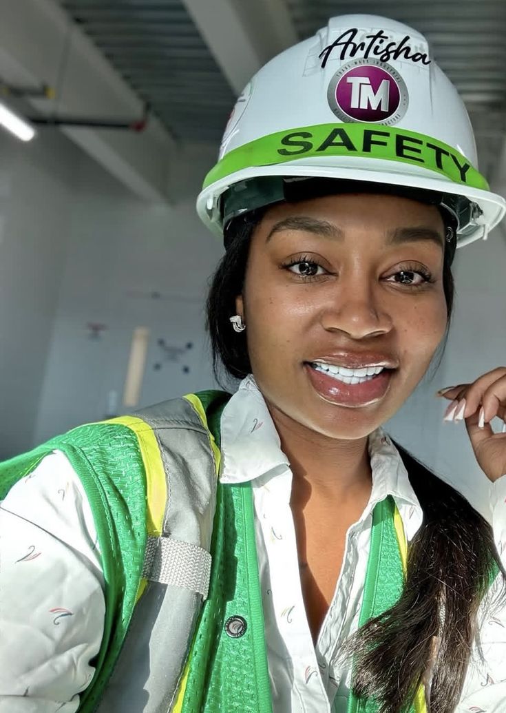 A construction safety inspector in a hard hat and hi-vis vest